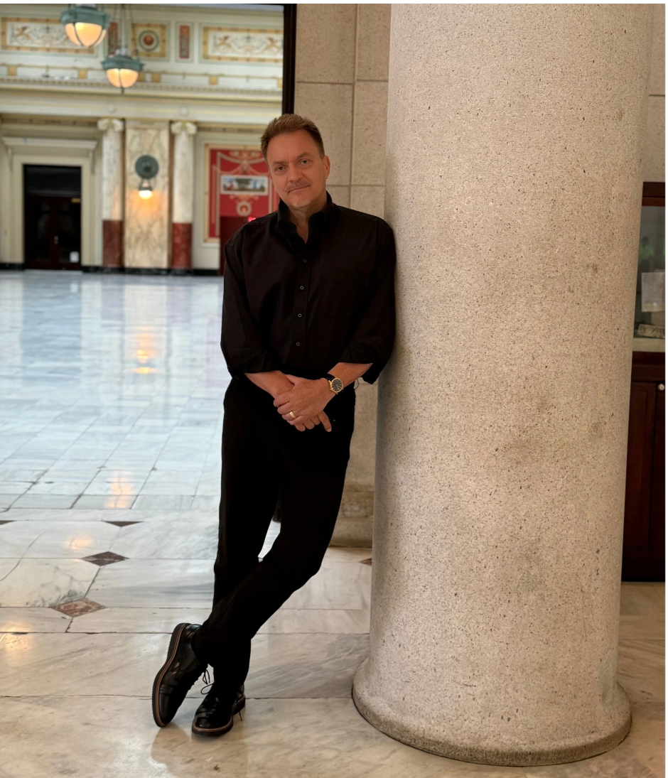 Dr. Gregory P. Seltz standing beside a marble column in a Washington, DC hall